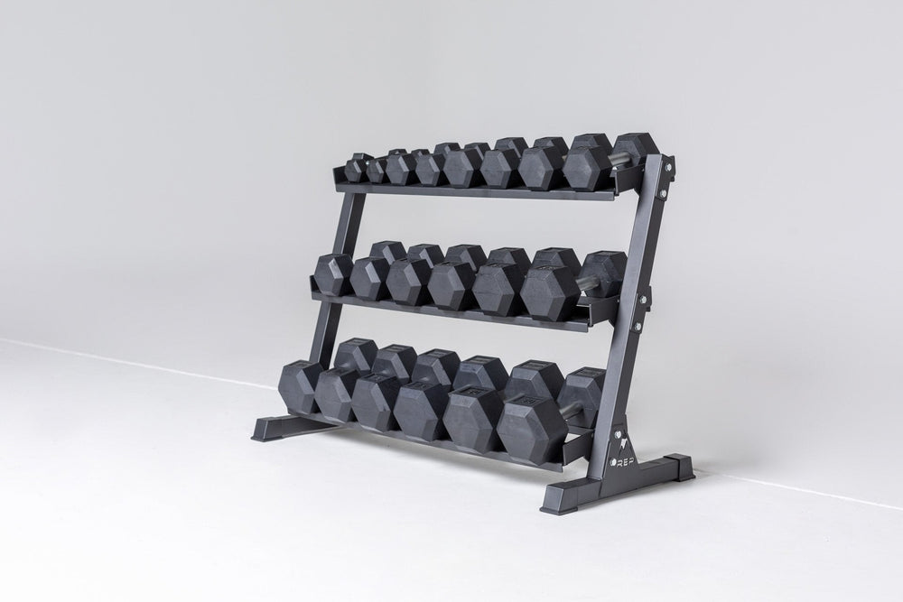 3-tiered matte black REP Dumbbell Rack storing a 5-50 REP dumbbell set, heavy-duty three-tier dumbbell rack with durable 11-gauge steel shelves, compact footprint, and 1" lip for secure storage  fits REP rubber hex and urethane dumbbells, available in multiple colors with easy zinc-coated hardware assembly from Rep Fitness UK | Shop Premium Gym Equipment for Home & Commercial Use, Best Online Gym Equipment UK