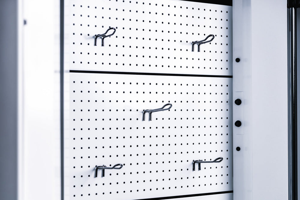 Pegboard storage hooks on a white Arcadia Max