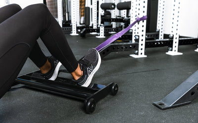 Athlete using glute ham roller with bands attached to a rack ideal for strengthening  posterior chain muscles lightweight and portable perfect for home gyms and commercial facilities from Rep Fitness UK | Shop Premium Gym Equipment for Home & Commercial Use Online | Best Online Gym 