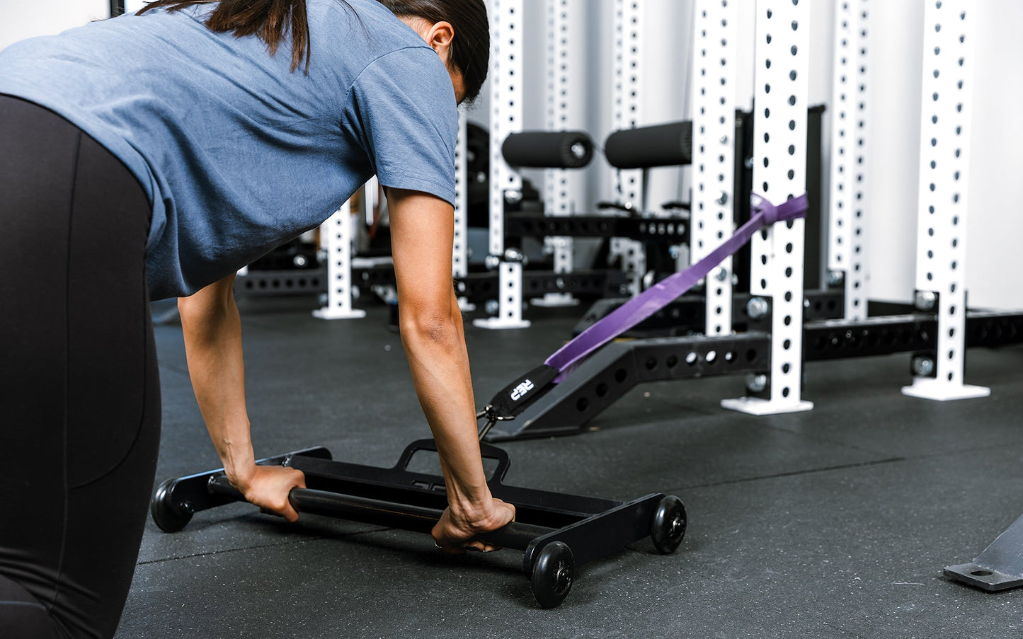 Athlete using glute ham roller with bands attached to a rack for ab exercises ideal for strengthening posterior chain muscles lightweight and portable perfect for home gyms and commercial facilities from Rep Fitness UK | Shop Premium Gym Equipment for Home & Commercial Use Online | Best Online Gym 