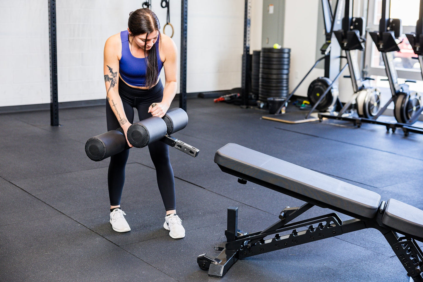 Athlete installing the Adjustable Bench Leg Roller Attachment 2.0 from Rep Fitness UK | Shop Best Premium Gym Equipment for Home & Commercial Use Online