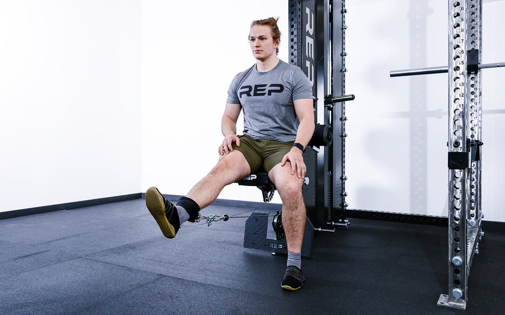 man sitting on Pegasus™ Attachment added to Adonis doing leg extensions from Rep Fitness UK | Shop Premium Gym Equipment for Home & Commercial Use, Best Online Gym Equipment UK
