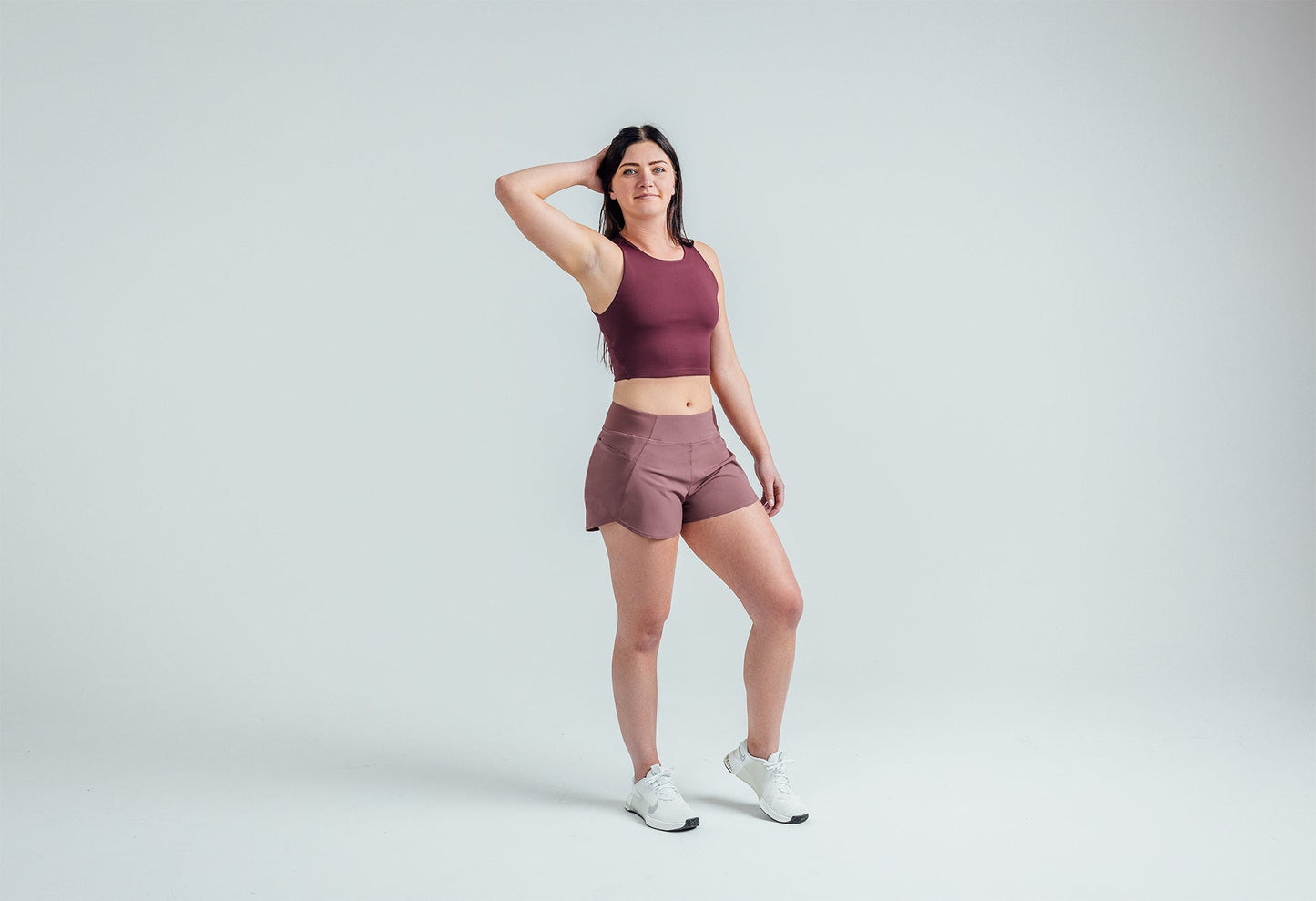 Full body shot: Athlete striking a pose in the Mauve Women’s Artemis Shorts