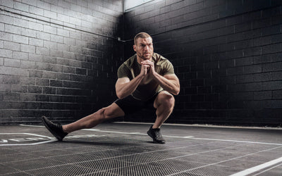 Athlete stretching wearing Heather Olive Sigmatech Shirt