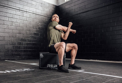 Athlete stretching in a Heather Olive Sigmatech Shirt