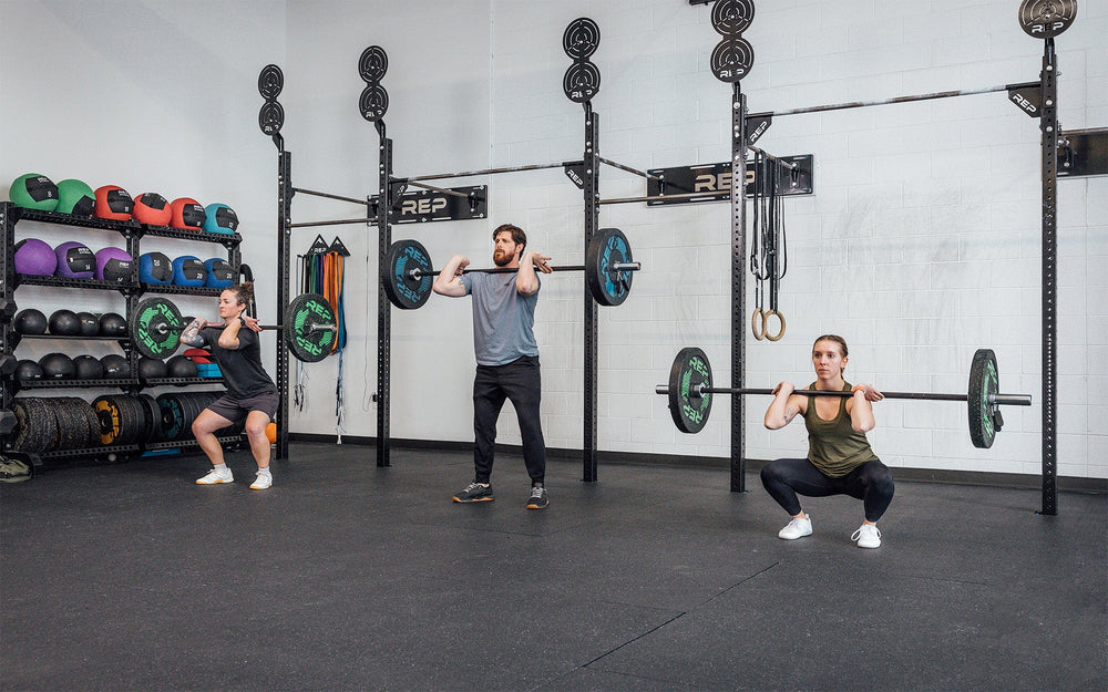 3 people lifting side by side using the Colorado Short Bar