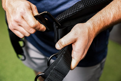Showing  a person putting on the belt squat belt and the g-hook mechanism from Rep Fitness UK | Shop Best Premium Gym Equipment for Home & Commercial Use Online