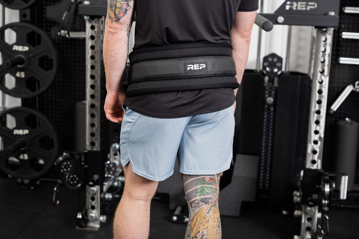 Person wearing the belt squat belt and showing the REP logo on the back from Rep Fitness UK | Shop Best Premium Gym Equipment for Home & Commercial Use Online 
