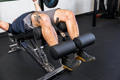 Athlete using the Adjustable Bench Leg Roller Attachment 2.0 from Rep Fitness UK | Shop Best Premium Gym Equipment for Home & Commercial Use Online