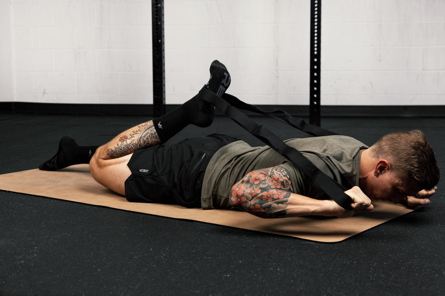 Person using stretching band for quad stretches from Rep Fitness UK | Shop Best Premium Gym Equipment for Home & Commercial Use Online