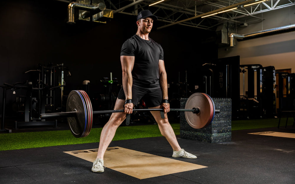 An athlete deadlifting with Rep Fitness Calibrated Steel Plates (KG) loaded on the barbell from Rep Fitness UK | Shop Best Premium Gym Equipment for Home & Commercial Use Online