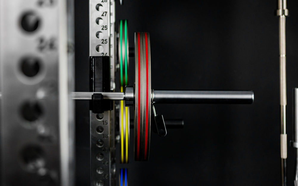 Front shot of Rep Fitness Calibrated Steel Plates (KG) loaded on a barbell, highlighting their thin width from Rep Fitness UK | Shop Best Premium Gym Equipment for Home & Commercial Use Online