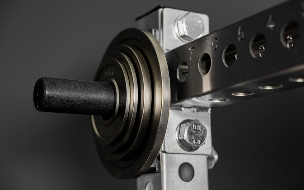 Rep Fitness Calibrated Steel Plates (KG) loaded on a weight horn, highlighting a calibrated tolerance from Rep Fitness UK | Shop Best Premium Gym Equipment for Home & Commercial Use Online