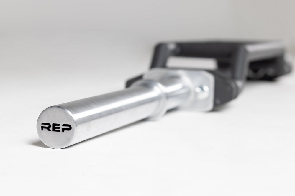 Cambered Swiss Bar premium chrome sleeve with REP logo, versatile multi-grip barbell with cambered design for greater range of motion and muscle engagement; features moderate knurling, round tubing for comfort, removable eyebolt for cable attachments, standard collar compatibility, and premium construction for advanced strength training from Rep Fitness UK | Shop Premium Gym Equipment for Home & Commercial Use, Best Online Gym Equipment