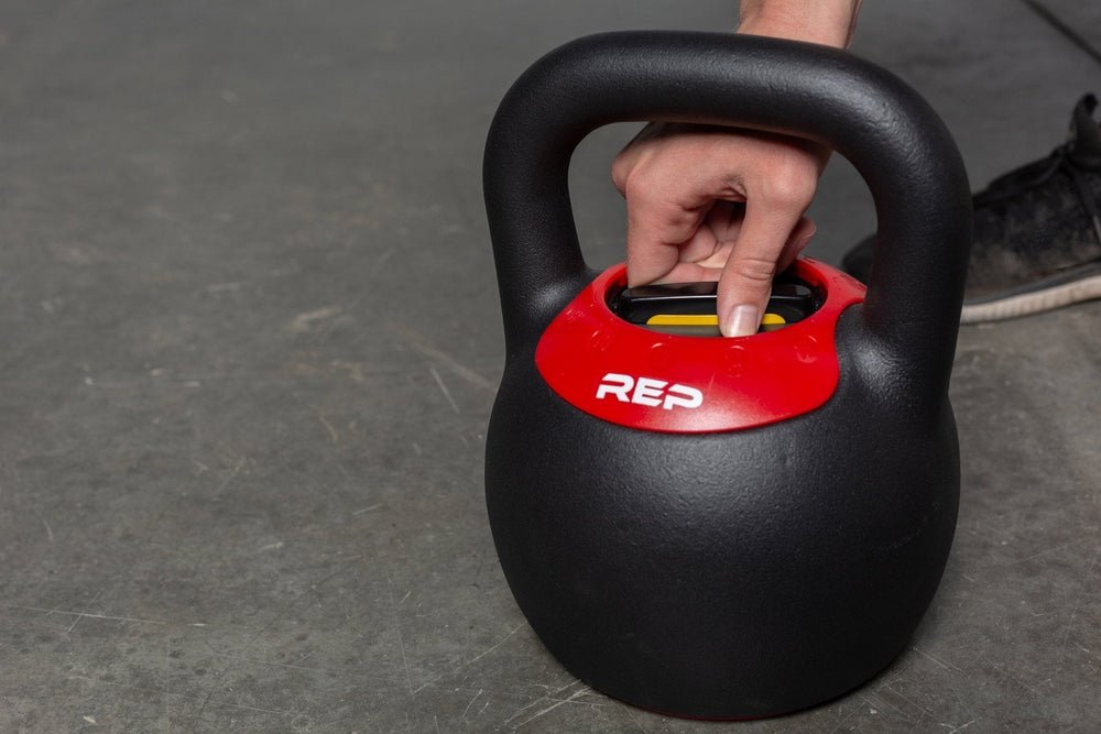 Close-up adjusting weights on the adjustable kettlebell from Rep Fitness UK, quick weight adjustment, non-slip matte powder coat, rubber base, and versatile for home gyms| Shop Premium Gym Equipment for Home & Commercial Use, Best Online Gym Equipment UK