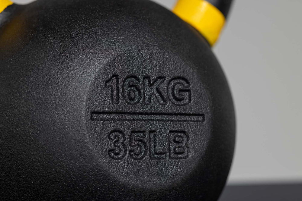 Close-up of 16kg imprint on kettlebell – premium cast-iron kettlebell from with color-coded handle, textured black coating for superior grip, and flat bases for stability; ideal for strength, conditioning, and full-body training; available individually or in sets from Rep Fitness UK | Shop Premium Gym Equipment for Home & Commercial Use, Best Online Gym Equipment UK