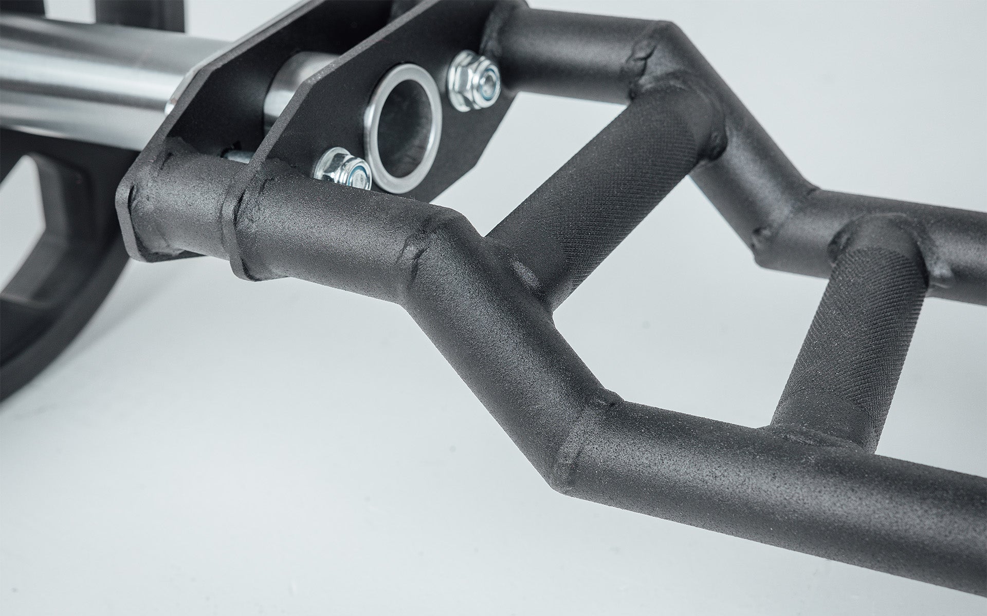 Close-up of Cambered Swiss Bar, premium chrome sleeve with REP logo, versatile multi-grip barbell with cambered design for greater range of motion and muscle engagement; features moderate knurling, round tubing for comfort, removable eyebolt for cable attachments, standard collar compatibility, and premium construction for advanced strength training from Rep Fitness UK | Shop Premium Gym Equipment for Home & Commercial Use, Best Online Gym Equipment