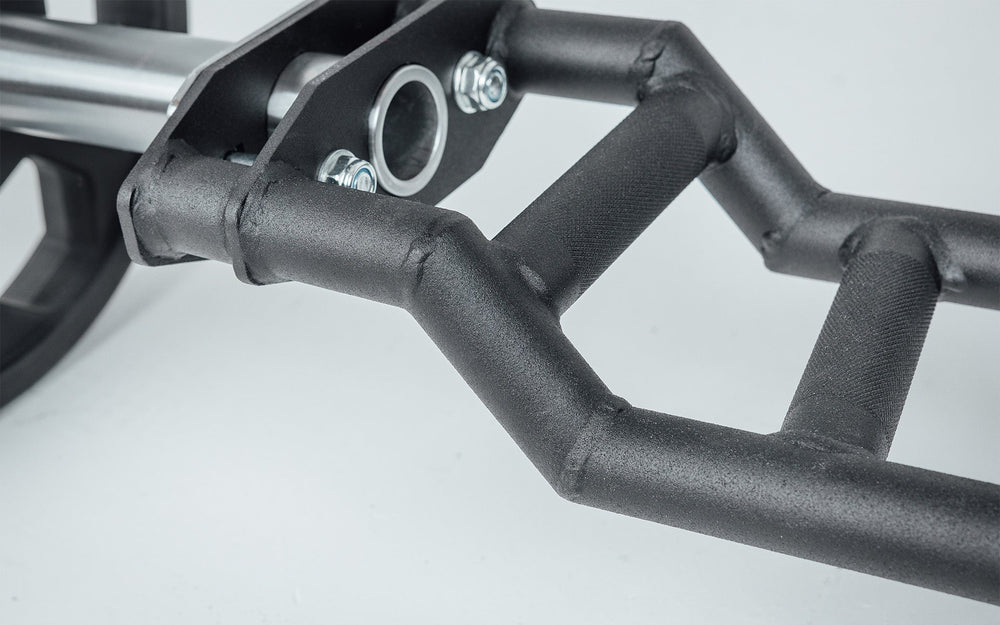 Close-up of Cambered Swiss Bar, premium chrome sleeve with REP logo, versatile multi-grip barbell with cambered design for greater range of motion and muscle engagement; features moderate knurling, round tubing for comfort, removable eyebolt for cable attachments, standard collar compatibility, and premium construction for advanced strength training from Rep Fitness UK | Shop Premium Gym Equipment for Home & Commercial Use, Best Online Gym Equipment