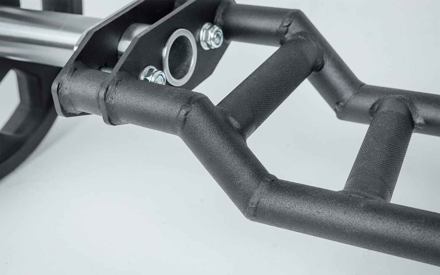 Close-up of Cambered Swiss Bar, premium chrome sleeve with REP logo, versatile multi-grip barbell with cambered design for greater range of motion and muscle engagement; features moderate knurling, round tubing for comfort, removable eyebolt for cable attachments, standard collar compatibility, and premium construction for advanced strength training from Rep Fitness UK | Shop Premium Gym Equipment for Home & Commercial Use, Best Online Gym Equipment