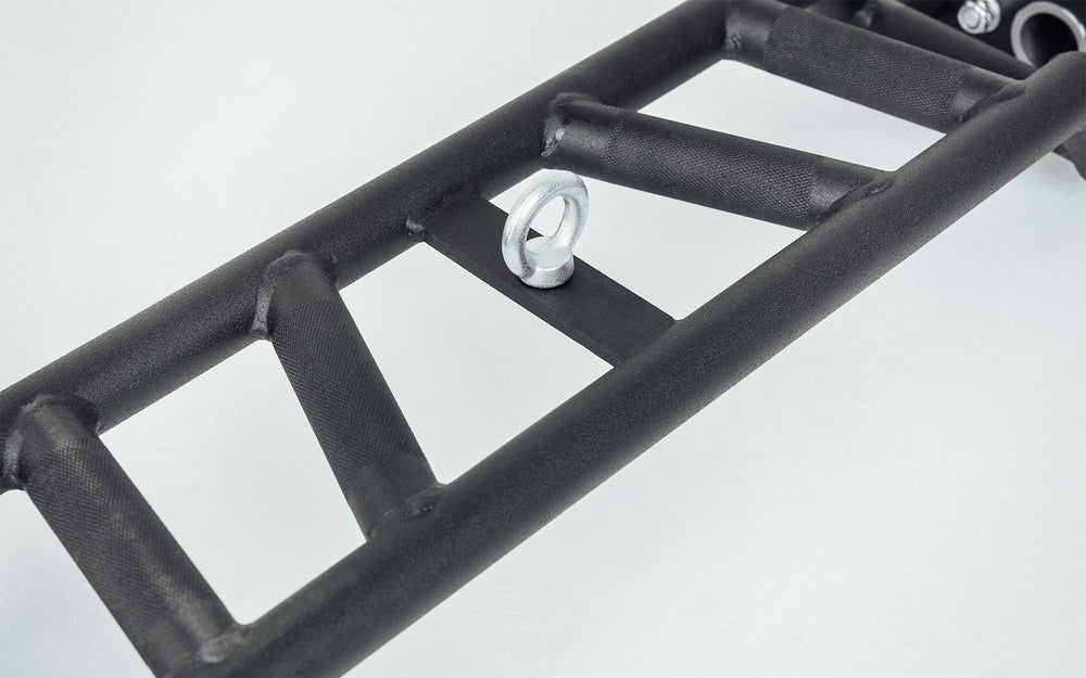 Close-up of Cambered Swiss Bar solid ladder construction, premium chrome sleeve with REP logo, versatile multi-grip barbell with cambered design for greater range of motion and muscle engagement; features moderate knurling, round tubing for comfort, removable eyebolt for cable attachments, standard collar compatibility, and premium construction for advanced strength training from Rep Fitness UK | Shop Premium Gym Equipment for Home & Commercial Use, Best Online Gym Equipment