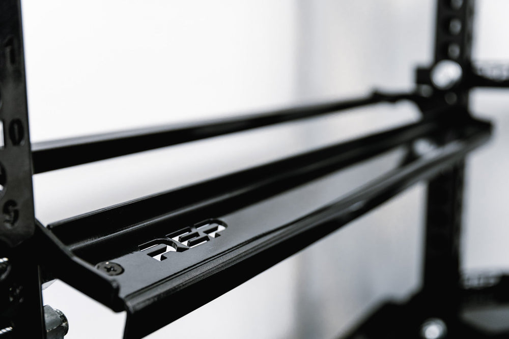 Close-up of Dumbbell Storage Shelf – heavy-duty 11-gauge steel dumbbell rack shelf with 600lb capacity, metallic black powder-coat finish, laser-cut REP logo, compatible with 4000 and 5000 Series racks, fits full 5–50lb dumbbell sets for organized, space-saving gym storage from Rep Fitness UK | Shop Premium Gym Equipment for Home & Commercial Use, Best Online Gym Equipment UK