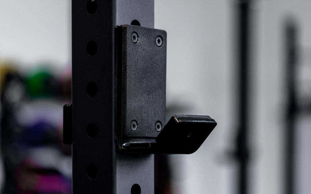Close-up of Standard J-Cup 2.0 – heavy-duty barbell holders for PR-5000 power rack; 3x3” 11-gauge steel with metallic black powder coat, soft plastic lining, recessed hardware, and 1,000 lb capacity for safe, scratch-free, and stable lifting from Rep Fitness UK | Shop Premium Gym Equipment for Home & Commercial Use, Best Online Gym Equipment UK