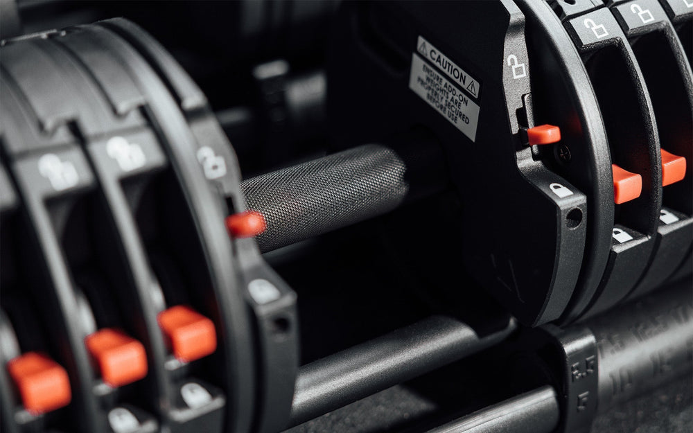 Close-up of grip of premium QuickDraw dumbbells with adjustable weight, fast switch adjustable  weight range technology and secure Lock-N-Load switches  from Rep Fitness UK | Shop Premium Gym Equipment for Home & Commercial Use, Best Online Gym Equipment UK