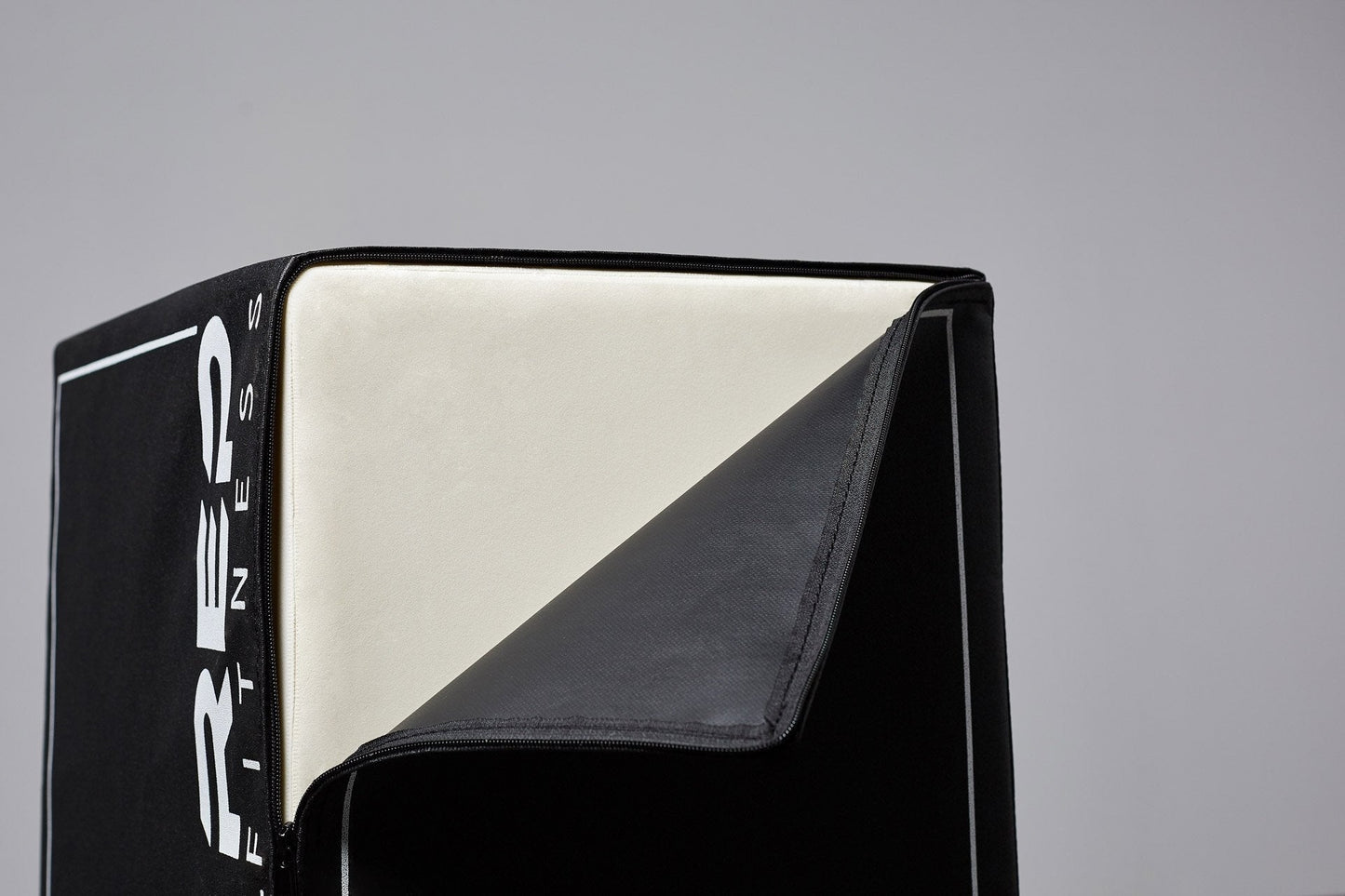 Close-up of unzipped 3-in-1 Soft Plyo Box showing inside material for safe plyometric training featuring a wood-core interior, impact-absorbing foam, non-slip textured vinyl, and clearly labeled height option for box jumps in home or garage gyms from Rep Fitness UK | Shop Premium Gym Equipment for Home & Commercial Use