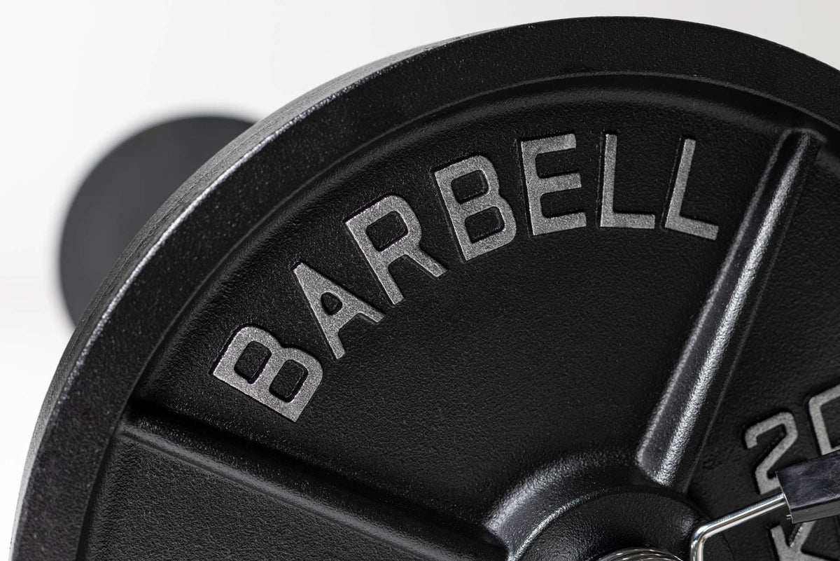 Close up view of the word "BARBELL" in silver lettering on a 45lb Old School Iron Plate from Rep Fitness UK | Shop Best Premium Gym Equipment for Home & Commercial Use Online