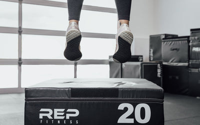 Female athlete performing box jumps on a 20" REP Stackable Soft Plyo Box from Rep Fitness UK | Shop Best Premium Gym Equipment for Home & Commercial Use Online