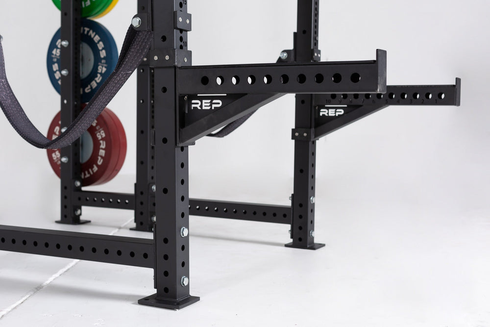 Close Up of Spotter Arms on power rack, heavy-duty 24” steel safety arms for power racks; 1,000 lb capacity with polyurethane lining, steel lip for bar security, 1” attachment holes, laser-engraved numbers, and durable matte black powder coat finish from Rep Fitness UK | Shop Premium Gym Equipment for Home & Commercial Use, Best Online Gym Equipment UK