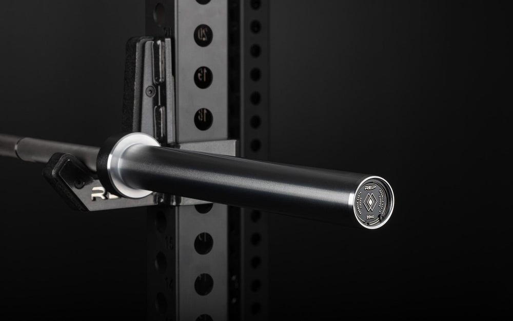 Closeup REP Fully Stainless Steel Double Black Diamond Power Bar, elite 20kg powerlifting barbell with ultra-aggressive mountain knurling, 29mm stiff shaft, bronze bushings, and IPF-standard specs, built for maximum grip and durability; available in stainless steel or Cerakote finishes for premium performance and corrosion resistance from Rep Fitness UK | Shop Premium Gym Equipment for Home & Commercial Use, Best UK Gym Equipment Online