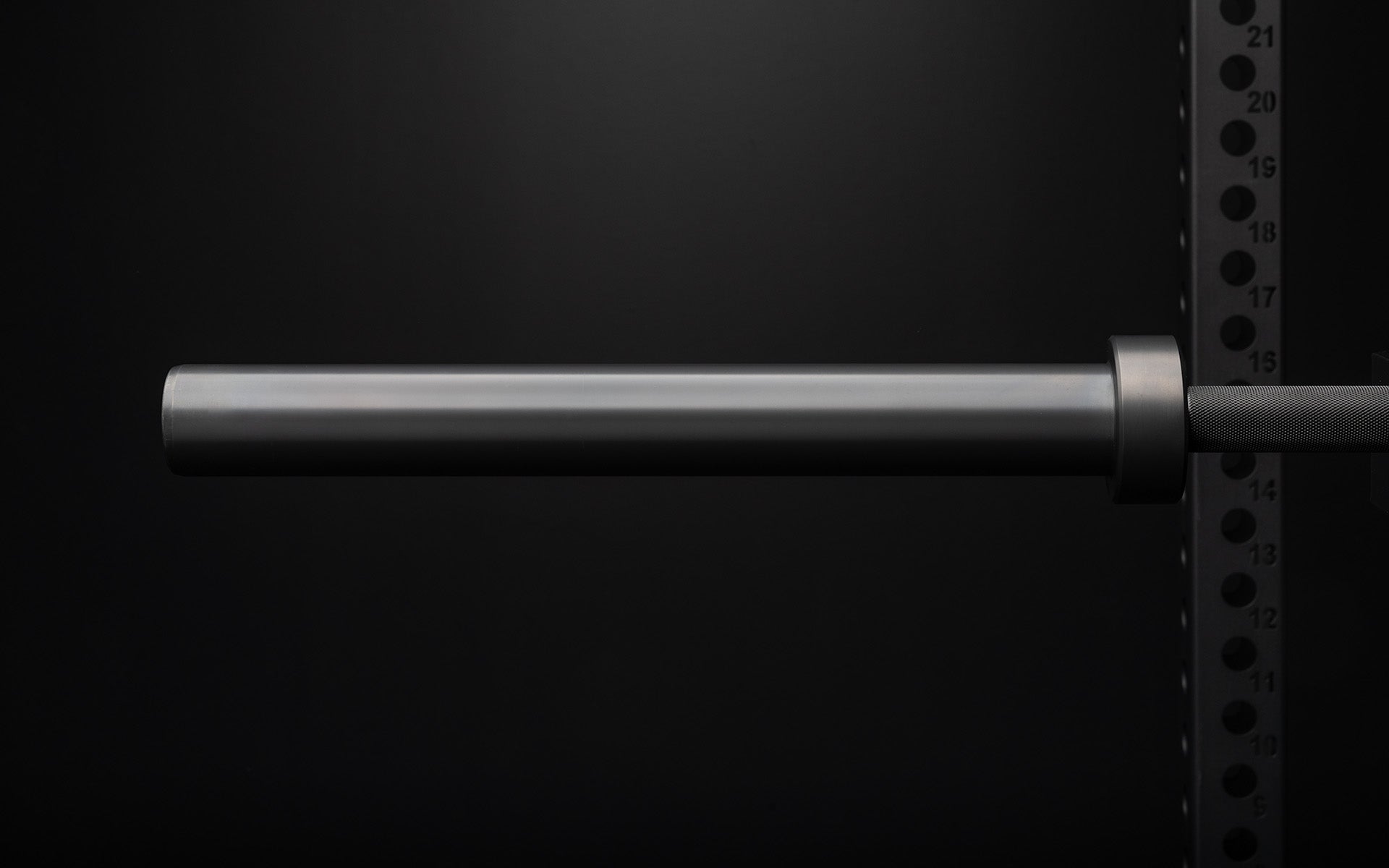 Closeup end of shaft of REP Fully Stainless Steel Double Black Diamond Power Bar, elite 20kg powerlifting barbell with ultra-aggressive mountain knurling, 29mm stiff shaft, bronze bushings, and IPF-standard specs, built for maximum grip and durability; available in stainless steel or Cerakote finishes for premium performance and corrosion resistance from Rep Fitness UK | Shop Premium Gym Equipment for Home & Commercial Use, Best UK Gym Equipment Online