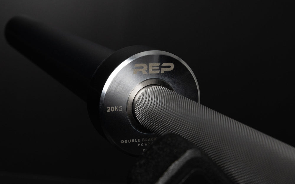 Closeup of grip and hand protection on REP Fully Stainless Steel Double Black Diamond Power Bar, elite 20kg powerlifting barbell with ultra-aggressive mountain knurling, 29mm stiff shaft, bronze bushings, and IPF-standard specs, built for maximum grip and durability; available in stainless steel or Cerakote finishes for premium performance and corrosion resistance from Rep Fitness UK | Shop Premium Gym Equipment for Home & Commercial Use, Best UK Gym Equipment Online
