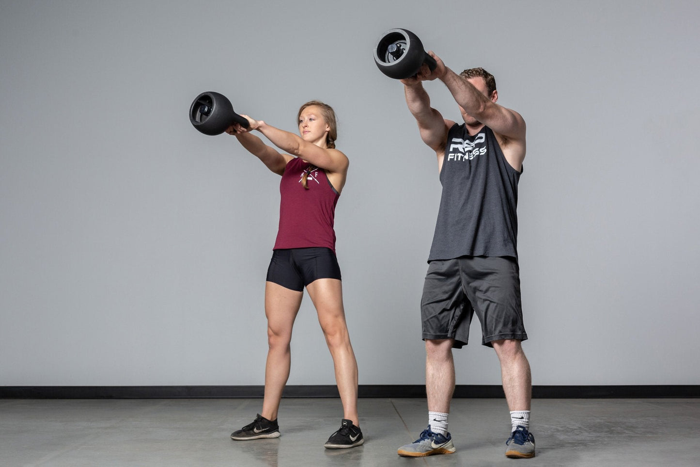 Couple Exercising with adjustable kettlebells from Rep Fitness UK, quick weight adjustment, non-slip matte powder coat, rubber base, and versatile for home gyms| Shop Premium Gym Equipment for Home & Commercial Use, Best Online Gym Equipment UK