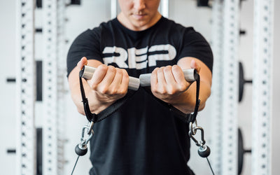 Steel D-handles being used for cable front raise from Rep Fitness UK | Shop Best Premium Gym Equipment for Home & Commercial Use Online