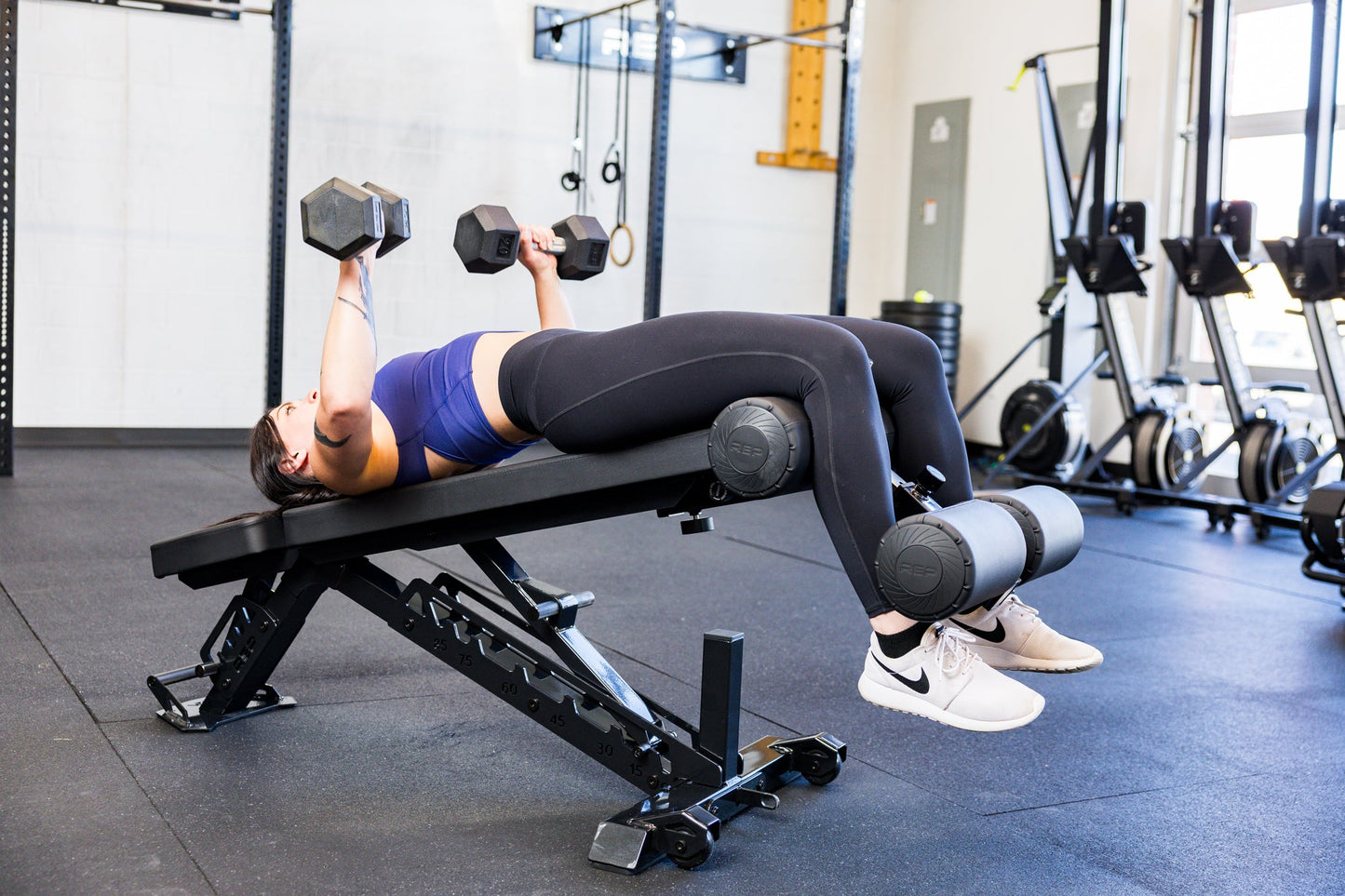 Athlete decline dumbbell bench pressing with the Adjustable Bench Leg Roller Attachment 2.0 from Rep Fitness UK | Shop Best Premium Gym Equipment for Home & Commercial Use Online