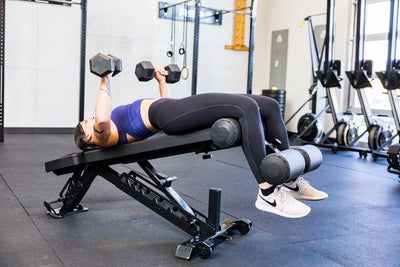 Athlete decline dumbbell bench pressing with the Adjustable Bench Leg Roller Attachment 2.0 from Rep Fitness UK | Shop Best Premium Gym Equipment for Home & Commercial Use Online