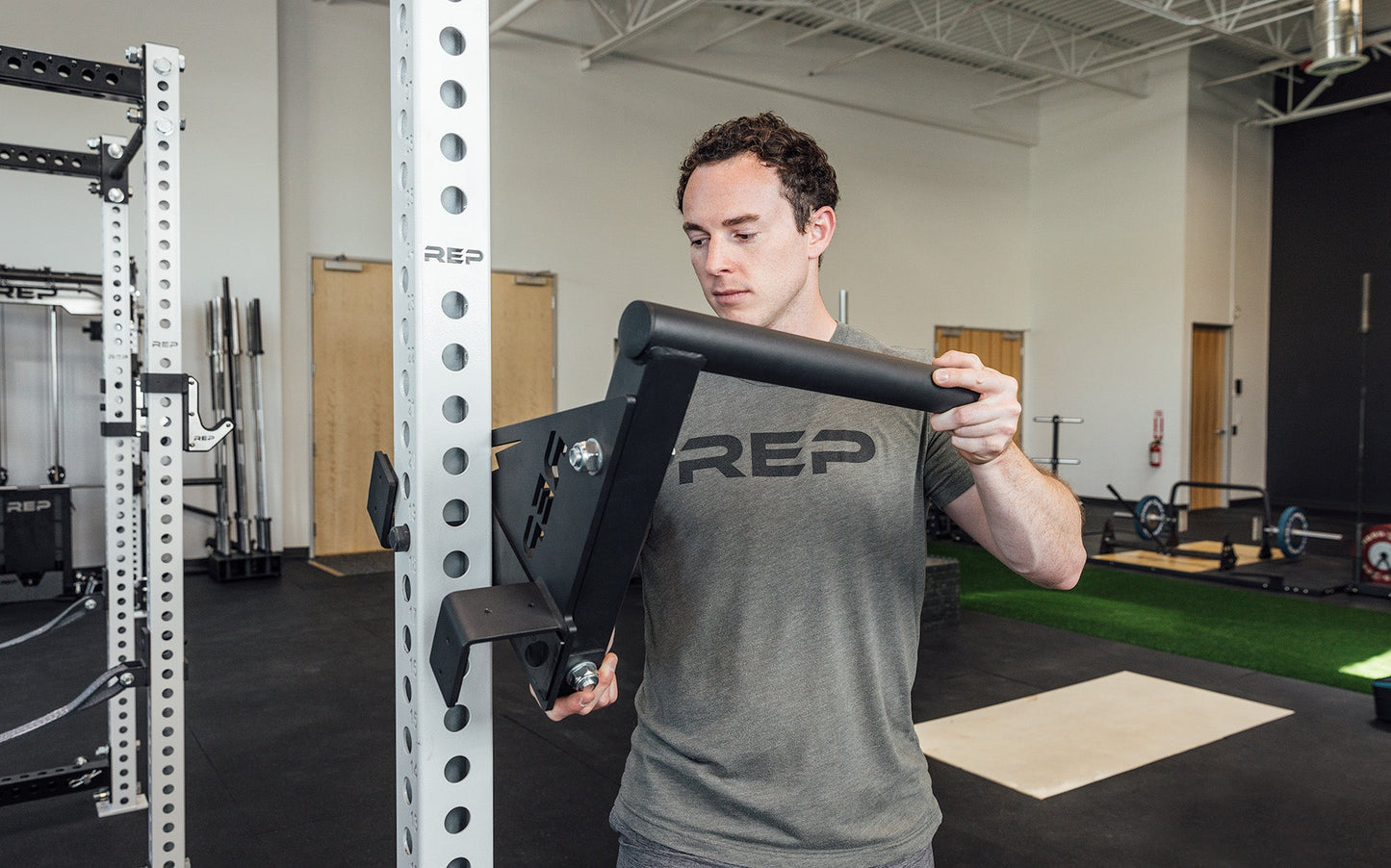 Drop-In Dip Attachment Being Installed on PR-5000 Power Rack, heavy-duty 11-gauge steel dip handles for power racks; 810 lb capacity, double C-cup mounting for stability, plastic-lined brackets to protect uprights, matte black powder coat textured grips, and laser-cut REP mountain design for premium aesthetic from Rep Fitness UK | Shop Premium Gym Equipment for Home & Commercial Use, Best Online Gym Equipment