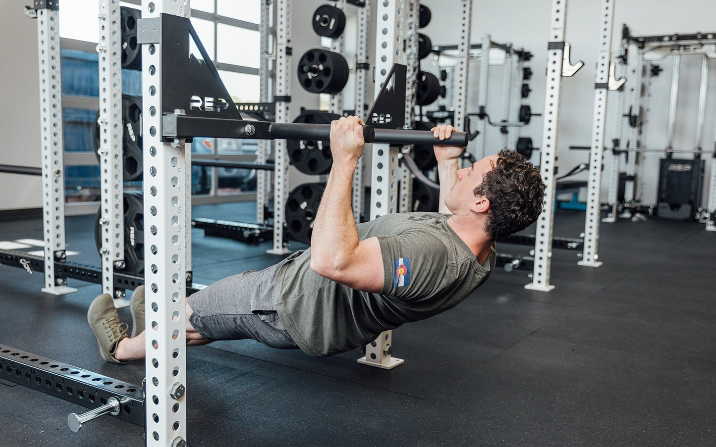 Drop-In Dip Attachment on PR-5000 Power Rack  Being Used for Rows by man, heavy-duty 11-gauge steel dip handles for power racks; 810 lb capacity, double C-cup mounting for stability, plastic-lined brackets to protect uprights, matte black powder coat textured grips, and laser-cut REP mountain design for premium aesthetic from Rep Fitness UK | Shop Premium Gym Equipment for Home & Commercial Use, Best Online Gym Equipment