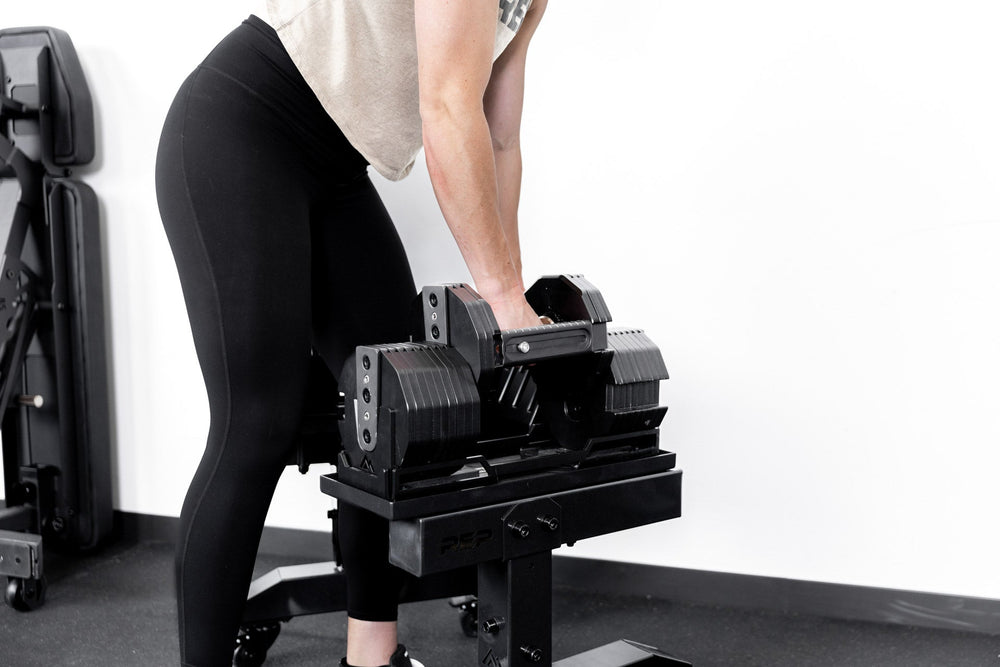 Dumbbell Stand Metallic Black Woman Lifting Dumbbell from_Rep_Fitness_UK_Shop_Premium_Gym_Equipment_for_Home_Commercial_Use_Online