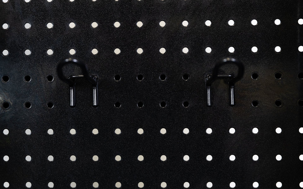 Close-up of pegboard storage hooks on Arcadia Functional Trainer