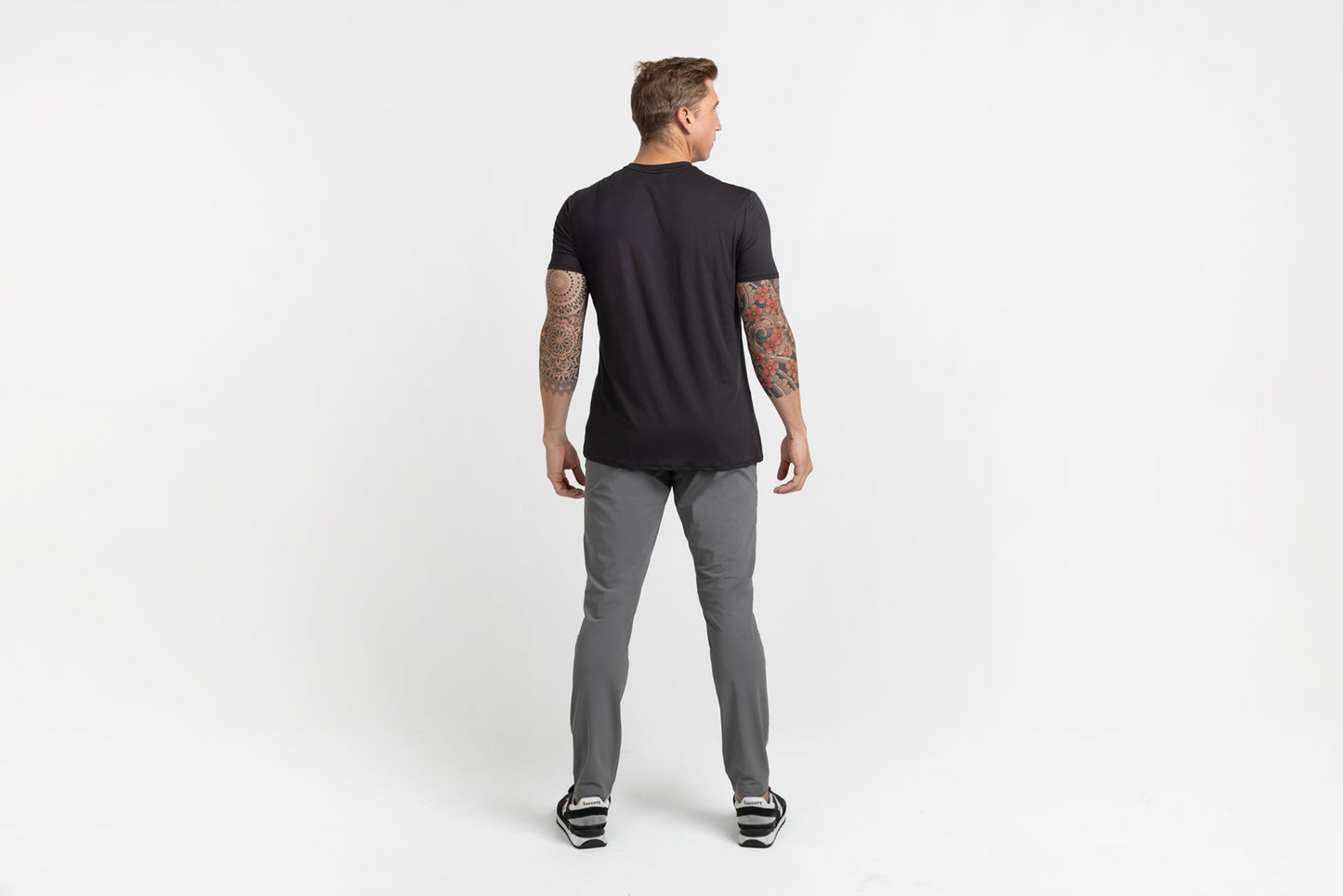 Rear shot of an athlete posing in grey Men's Felix Pants 2.0