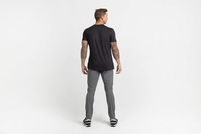 Rear shot of an athlete posing in grey Men's Felix Pants 2.0