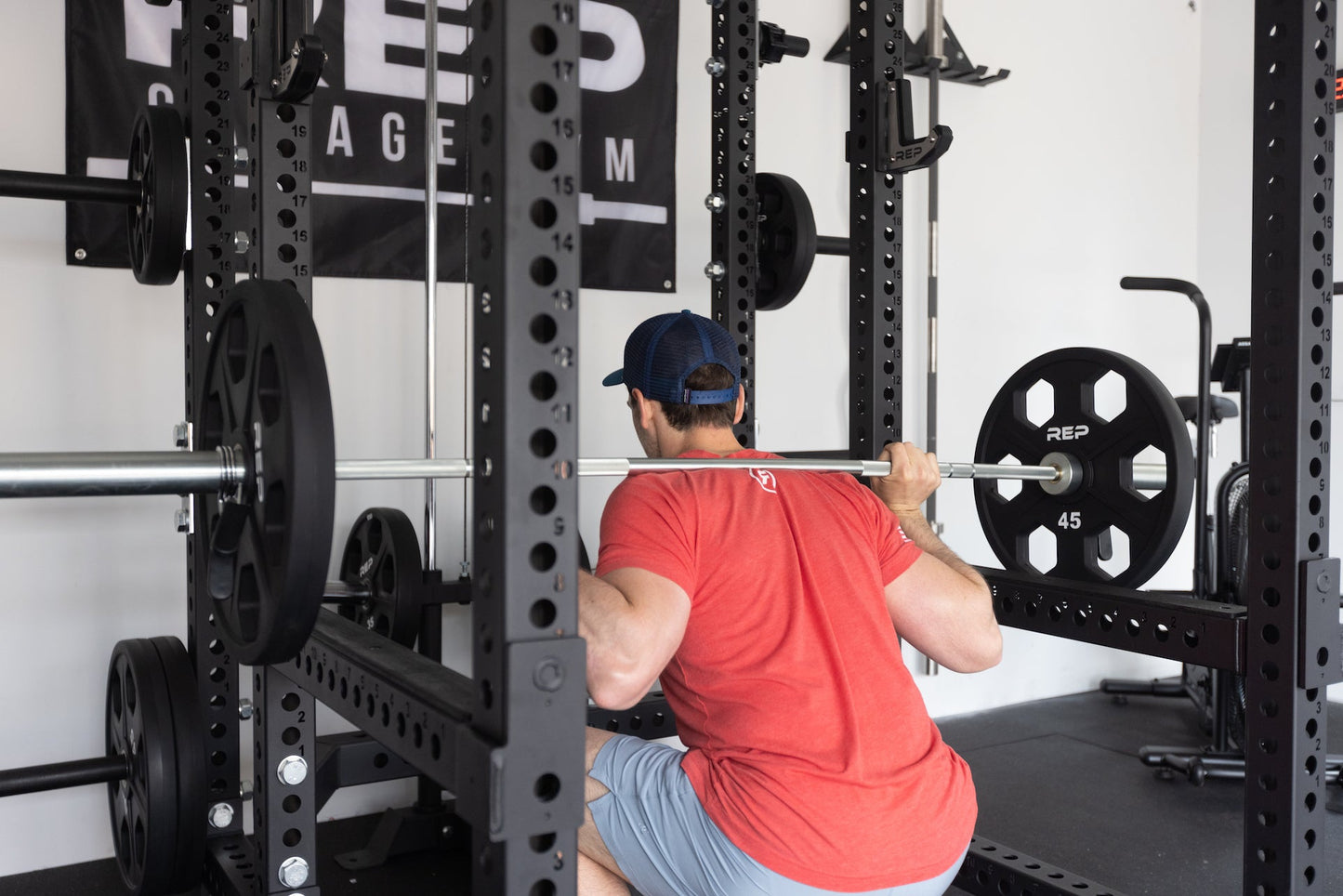 Flip-Down Safeties on PR-5000 Power Rack Being Used As Safety for Squats, heavy-duty 11-gauge steel safety arms for power racks; 1,000 lb and 700 lb capacities, quick-lock clevis pin design, protective liners for barbell and uprights, and 1” side holes compatible with Leg Roller, Utility Horn, and Band Peg attachments rom Rep Fitness UK | Shop Premium Gym Equipment for Home & Commercial Use, Best Online Gym Equipment UK