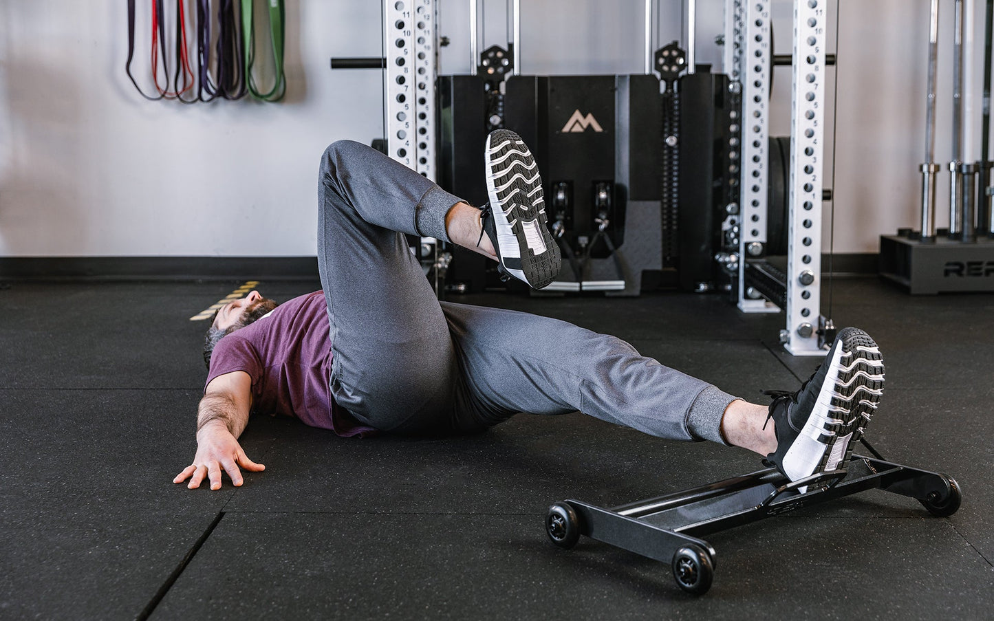 Athlete doing exercises with 1 foot on the Glute Ham Roller ideal for strengthening posterior chain muscles lightweight and portable perfect for home gyms and commercial facilities from Rep Fitness UK | Shop Premium Gym Equipment for Home & Commercial Use Online | Best Online Gym 