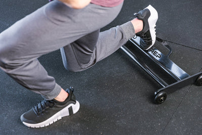 Athlete with 1 foot on the Glute Ham Roller ideal for strengthening posterior chain muscles lightweight and portable perfect for home gyms and commercial facilities from Rep Fitness UK | Shop Premium Gym Equipment for Home & Commercial Use Online | Best Online Gym 