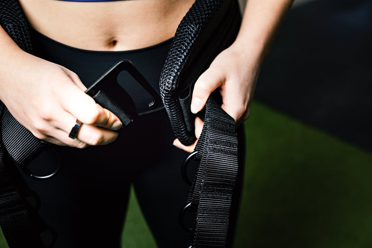 Showing person putting on belt squat belt and the g-hook mechanism from Rep Fitness UK | Shop Best Premium Gym Equipment for Home & Commercial Use Online