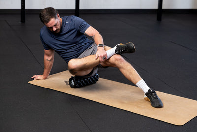 Man using High Density Foam Roller to roll out glutes on a cork yoga mat in a gym setting _Online
from Rep Fitness UK | Shop Best Premium Gym Equipment for Home & Commercial Use Online