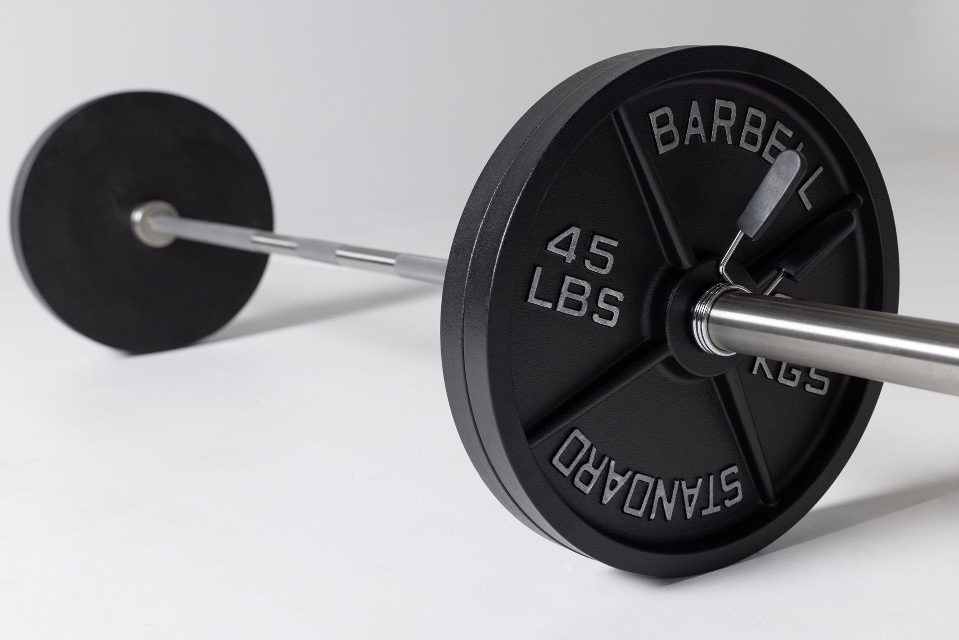 Barbell loaded with two pairs of 45lb Old School Iron Plates and spring clips. from Rep Fitness UK | Shop Best Premium Gym Equipment for Home & Commercial Use Online